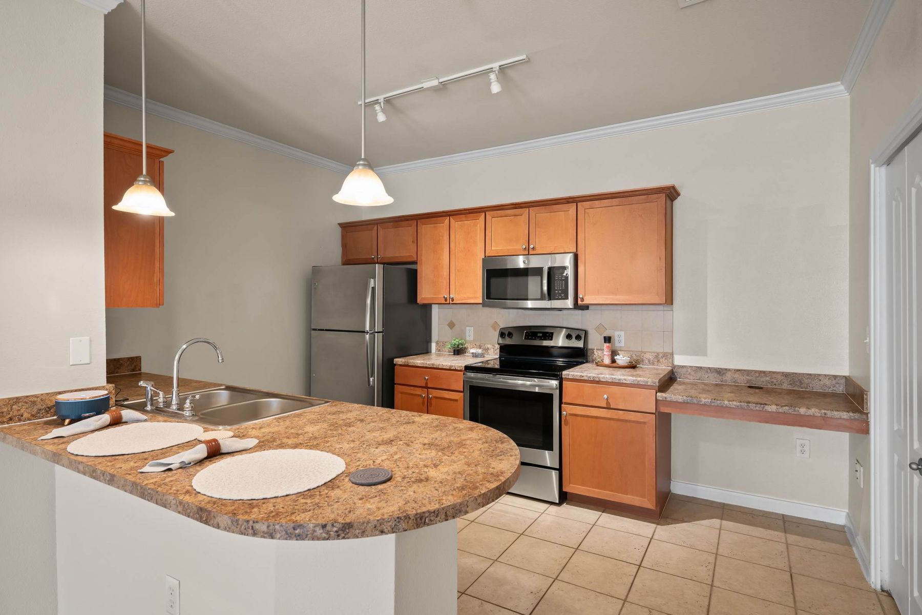 Luxury apartment kitchen with stainless steel appliances, granite countertops, and lots of storage space